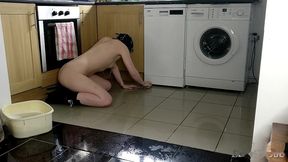 slave cleans kitchen floor in chains