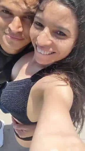 Daniela Duran in a bikini at a beach making out with kissing a random stranger