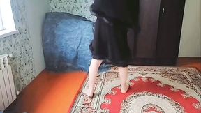 Stunning femboy adjusting skirt in front of mirror