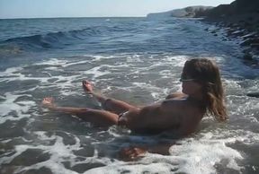 Lovely topless hottie at the beach topless and wet