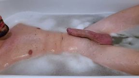 Boy plays with his cock and then masturbates while bathing