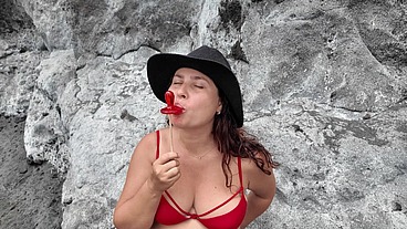 A StepMom practices sucking on a candy on the beach. Then tests her skills on her StepSon's Dick