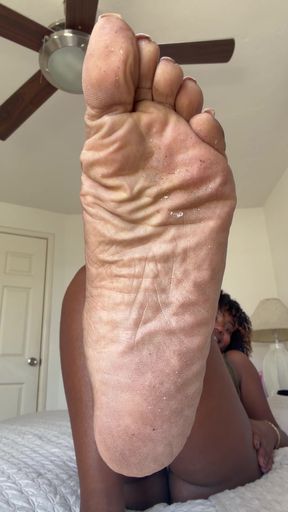 Ebony femdom plays with dirty feet in BDSM session