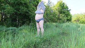 Naughty girl pisses in park while undressed, big ass and big knockers on display