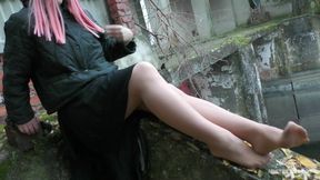 Outdoor nylon legs plays with autumn leafs