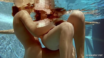 Two sultry sirens splash in scorching swimming waters, their bodies begging to be ravaged