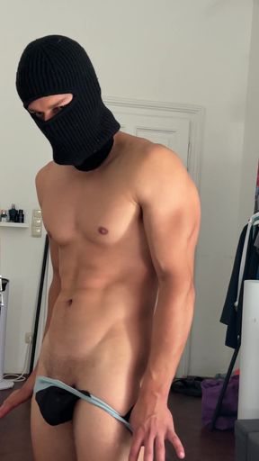 Young bodybuilder flexing his muscles in front of the mirror
