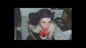 Cute cd girl, beautiful eyes and face. Kissing, licking and sucking a playstation controller. Sweet cd girl next door.