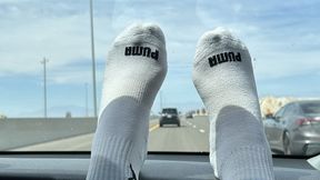 Long roadtrip means foot rubs and sock removal on dashboard while my soft pink wrinkled soles take in the view. Look at my blue long toes as they press against his windshield.