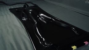 Orgasms in a black latex bed with a pear gag