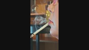 Close up profile view holding VS 120 in mouth