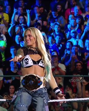 Busty blonde wrestler shows off tight thong and muscular abs