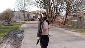 Naked wife struts confidently through the city streets in a public area