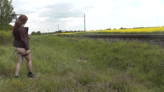 Naked in public. MILF pissing on train tracks and putting on panties near passing train. Golden Rain