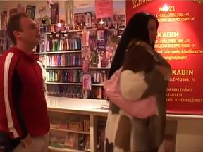 Fun in the adult book store for a big tits brunette and her black stud