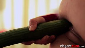 Euro babe stuffs her wet pussy with a cucumber in high heels