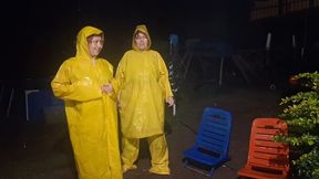 Two girls in rainwear playing in the rain