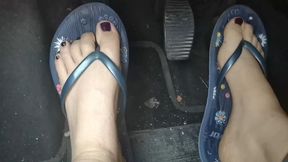 Sweaty feet in really tasty flip flops pedal pumping on the pedals of the car 4K