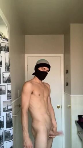 Masked twink jerks a load out in bathroom