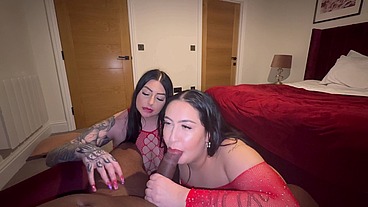 Two thick girls in red share hung black stud ends with cum on their face