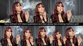 Sexy redhead with black eyeshadow and clear glossy lips smoking marlboro gold