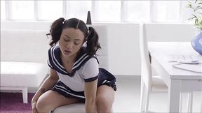 Pigtailed teen brunette is wearing school uniform while rubbing her soaking wet pussy on the couch