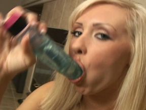 Blonde bitch is shoving a firm dildo down her throat