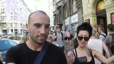 Tattooed and busty MILF pornstar talks kinky during a strolling interview outdoors