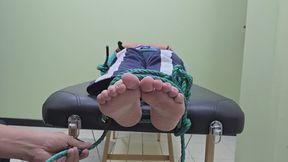 Sheila getting wrapped up for a memorable tickling session (feet camera)