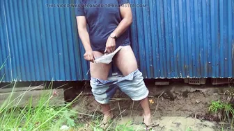 Twink pisses his denim shorts in public during a storm
