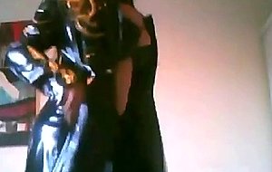 Spanish tgirl poses wearing a latex coat
