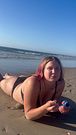 Sexy girl is smoking on the sand