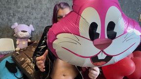 girl in latex poping foil balloons