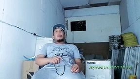 a horny construction worker strokes his hard dick deep inside the warehouse