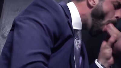 Guy is suit bends down his co-worker and fucks him