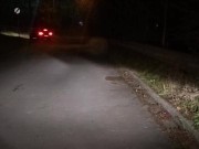 Naked on roadside with passing car