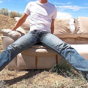 Public jeans wetting on an abandoned couch