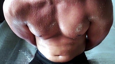 Muscular gladiator restrained with arms behind his back in a sweaty BDSM session