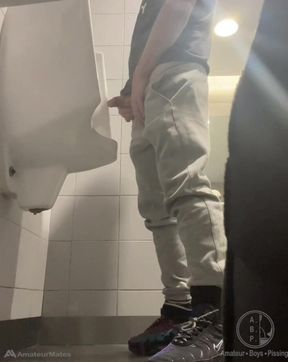 2 Boys in Sneakers Having Fun at Public Toilets' Urinal