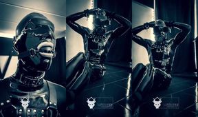 Sweaty muffled slave chokes on latex mask and harness