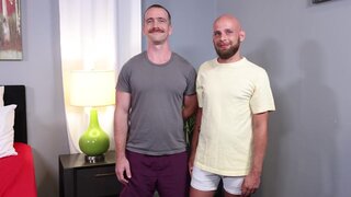 The shorter fellow is ready to top the lad with a moustache