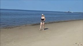 Big ass in denim shorts on the beach