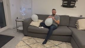 JL blowing up some pretty white balloons