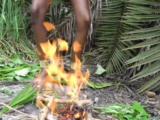 Sexy Afro native woman cooking in the jungle