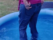 Ripped jeans jumping into a swimming pool soaking her ripped jeans