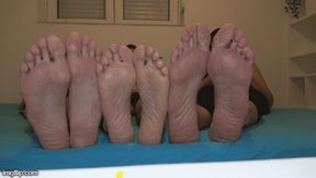 small foot of a man between two big woman feet