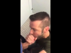 Handsome guy sucks dick in restroom stall