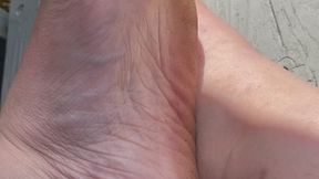 Foot Flexing With Green Toe Nails Outside