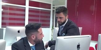 Office hunk taking care of his prey in front of the computer