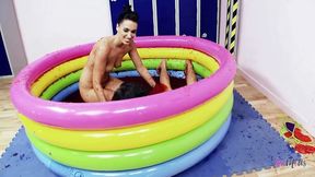 Brunette lesbians jump in a pool with food to wrestle and their big tits